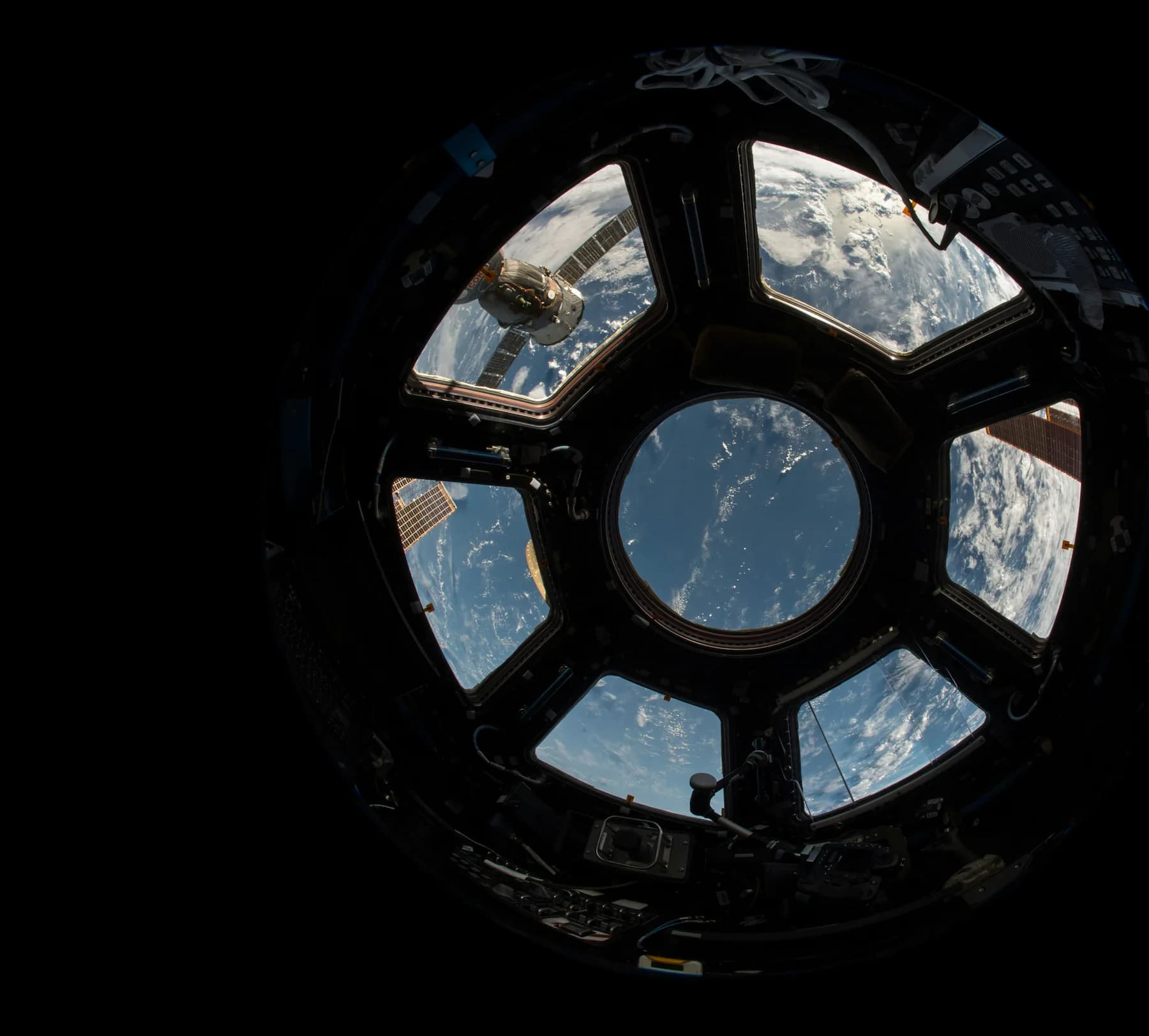 View of the Earth from the cupola of the International Space Station, showing the planet and the stars.